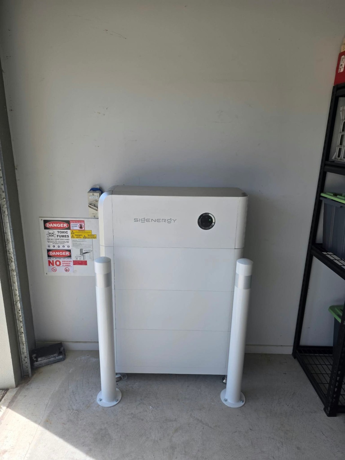 A Sigenergy battery installation with protective bollards.